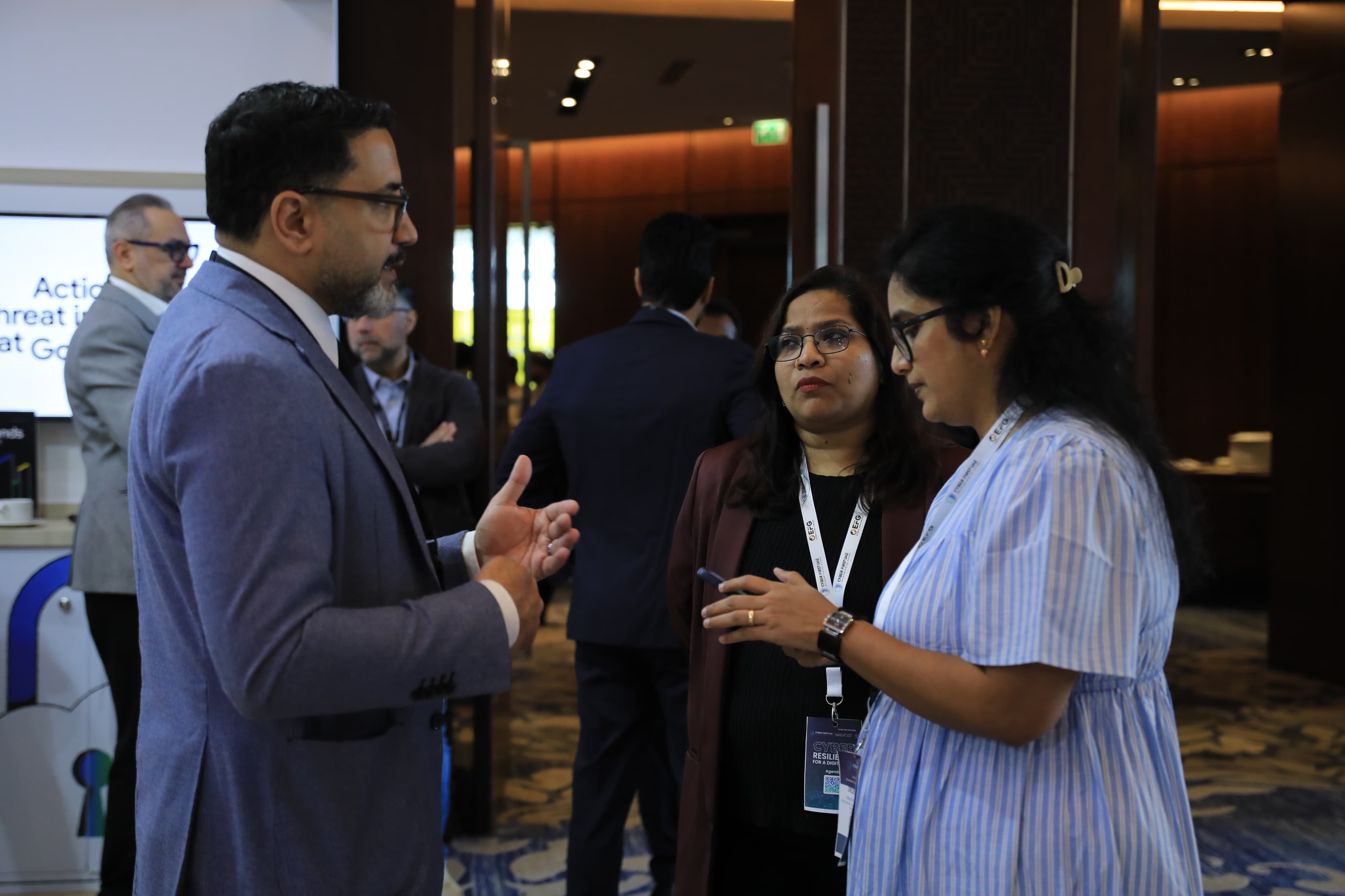 Delegates networking in the exhibition area at Cyber First UAE