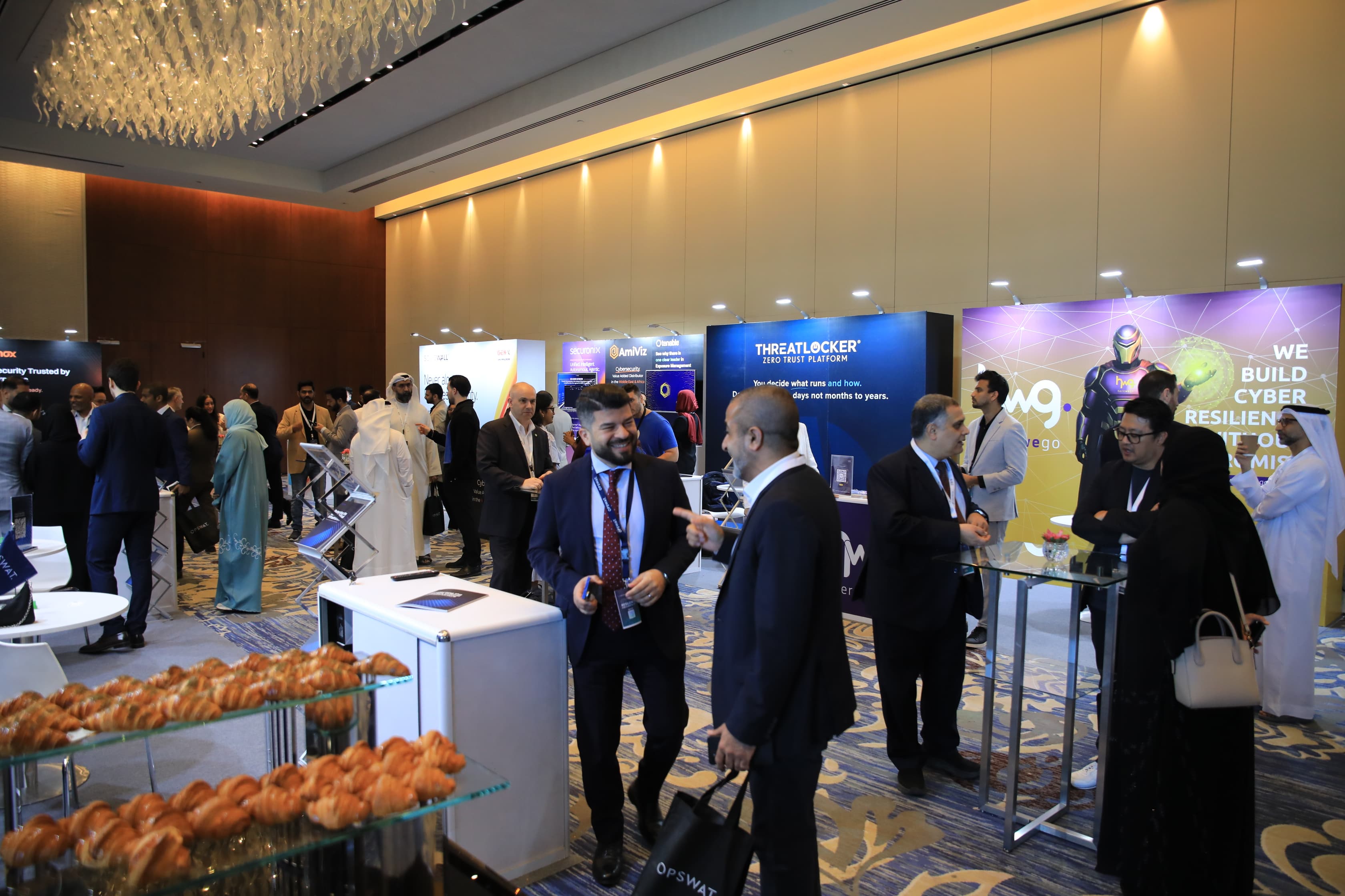 Delegates networking in the exhibition area at Cyber First UAE